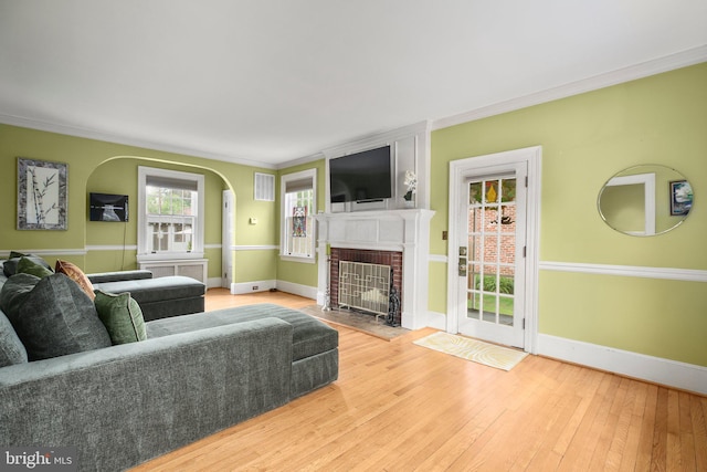 1107 Kenmore Ave, Fredericksburg, VA 22401 - living area with a brick fireplace, wood-type flooring, crown molding, plenty of natural light, and baseboards