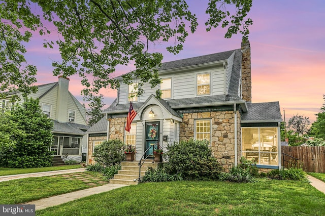 1107 Kenmore Ave, Fredericksburg, VA 22401 - view of front of house featuring stone siding, a chimney, a sunroom, and a shingled roof