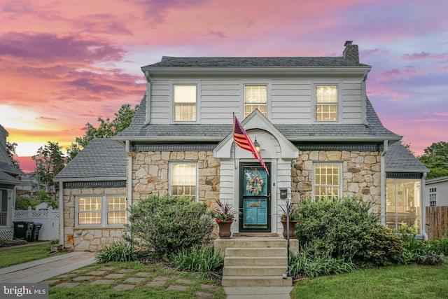 1107 Kenmore Ave, Fredericksburg, VA 22401 - view of front of property with stone siding, a chimney, and a high end roof