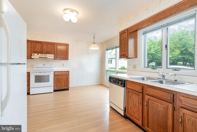 1813 Creek View Ct, New Cumberland, PA 17070 - kitchen featuring white appliances, under cabinet range hood, wallpapered walls, a sink, and light wood-style floors