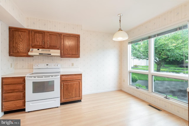 1813 Creek View Ct, New Cumberland, PA 17070 - kitchen featuring white electric stove, under cabinet range hood, wallpapered walls, light wood finished floors, and brown cabinets