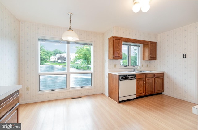 1813 Creek View Ct, New Cumberland, PA 17070 - kitchen featuring light wood-type flooring, dishwasher, brown cabinetry, and wallpapered walls