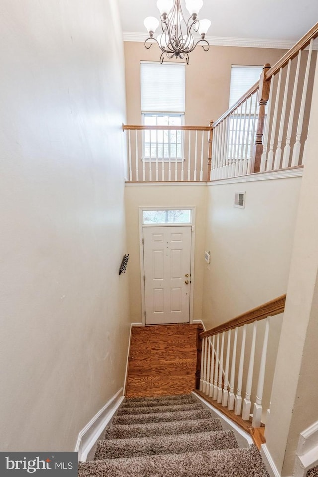 3416 Barnhouse Dr, Edgewater, MD 21037 - stairs featuring a chandelier, crown molding, plenty of natural light, a towering ceiling, and baseboards
