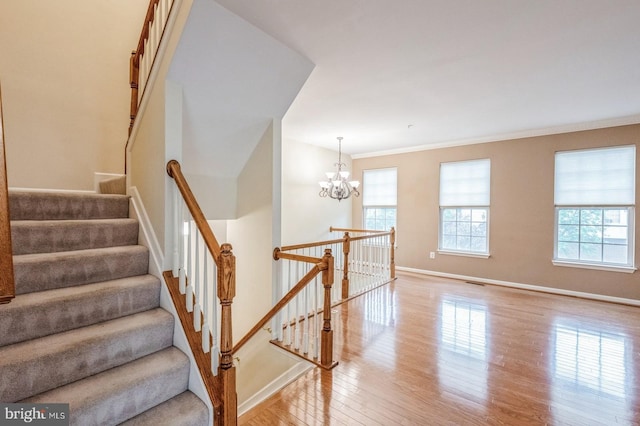 3416 Barnhouse Dr, Edgewater, MD 21037 - staircase featuring wood finished floors, a chandelier, baseboards, and ornamental molding