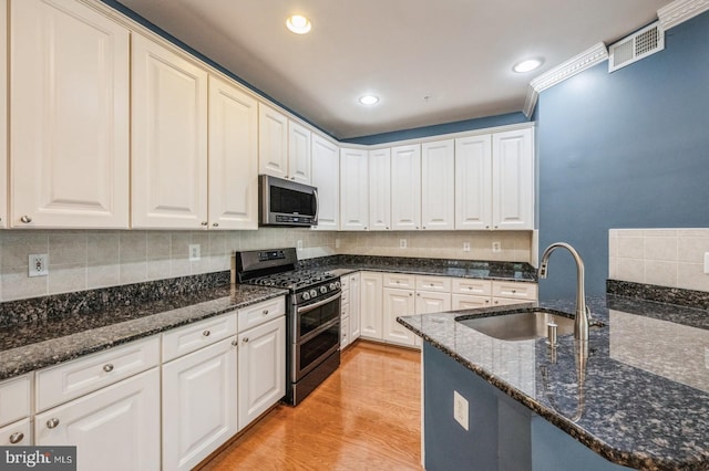 3416 Barnhouse Dr, Edgewater, MD 21037 - kitchen with appliances with stainless steel finishes, a sink, white cabinetry, decorative backsplash, and dark stone counters