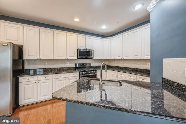 3416 Barnhouse Dr, Edgewater, MD 21037 - kitchen with appliances with stainless steel finishes, a sink, dark stone countertops, white cabinetry, and recessed lighting