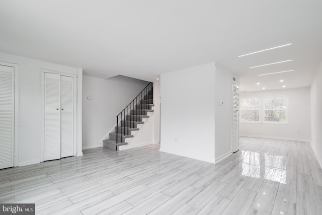1722 Allendale Pl, Landover, MD 20785 - unfurnished living room with stairs, light wood finished floors, and baseboards