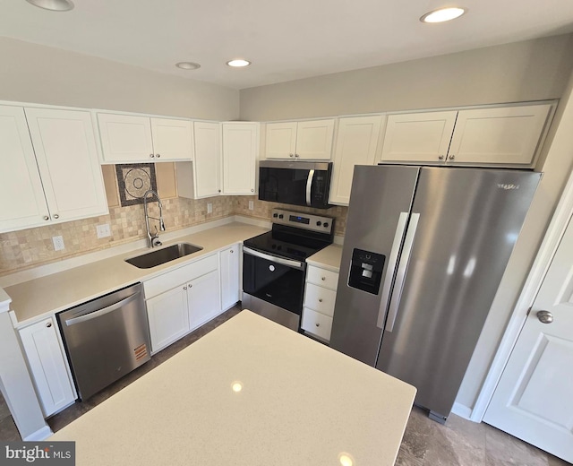 1248 Steed St, Ranson, WV 25438 - kitchen with stainless steel appliances, a sink, white cabinetry, decorative backsplash, and recessed lighting
