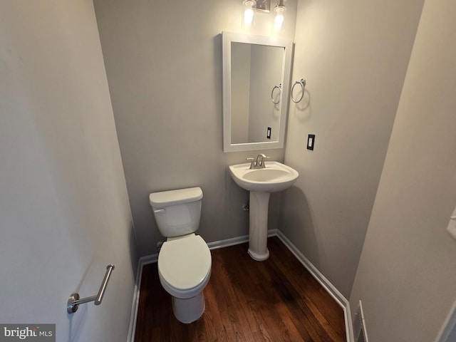 1248 Steed St, Ranson, WV 25438 - bathroom featuring wood finished floors, toilet, baseboards, and a sink