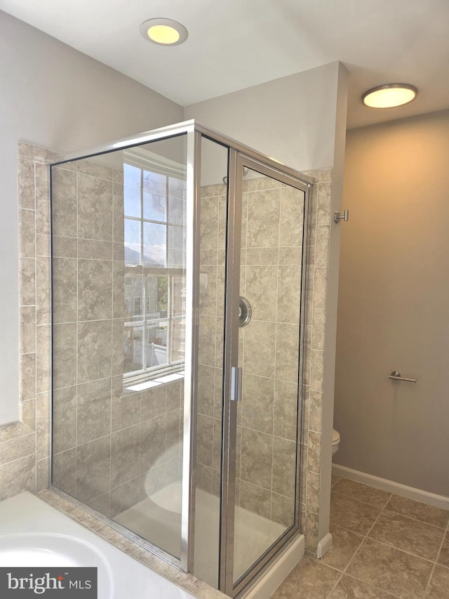 1248 Steed St, Ranson, WV 25438 - bathroom featuring a stall shower, toilet, tile patterned flooring, a tub, and baseboards