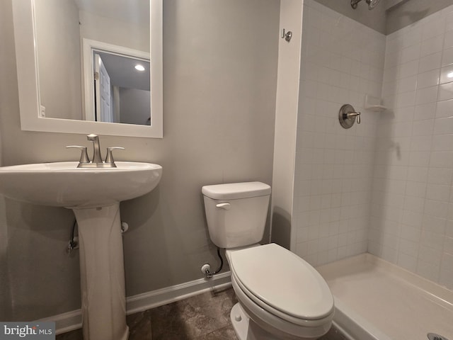 1248 Steed St, Ranson, WV 25438 - bathroom with tiled shower, toilet, baseboards, and a sink