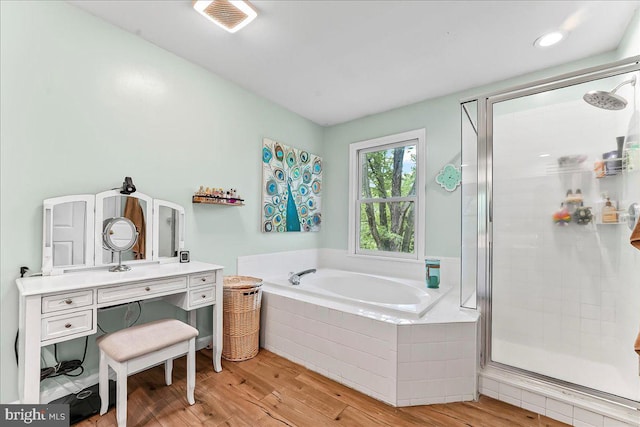 11 White Oak Dr, West Grove, PA 19390 - bathroom featuring a garden tub, a stall shower, wood finished floors, and vanity