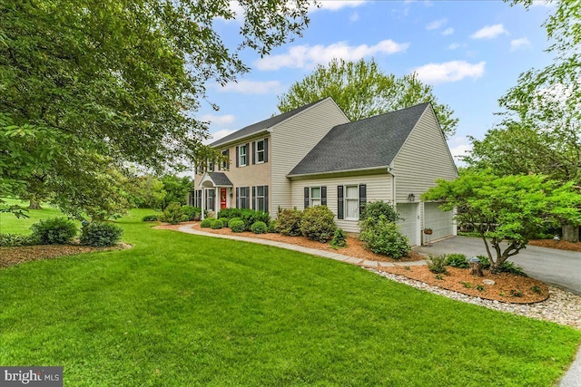 11 White Oak Dr, West Grove, PA 19390 - colonial house featuring asphalt driveway, a front yard, an attached garage, and a shingled roof