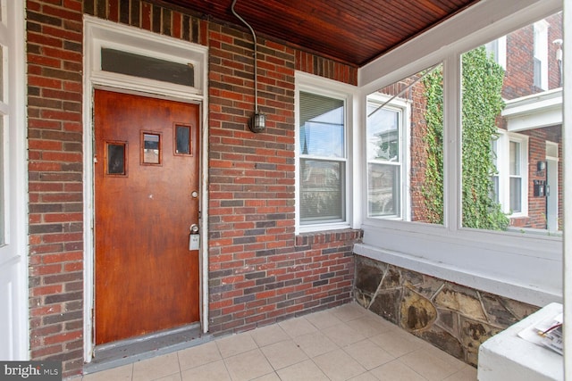 6745 Woodley, Dundalk, MD 21222 - doorway to property featuring brick siding and covered porch