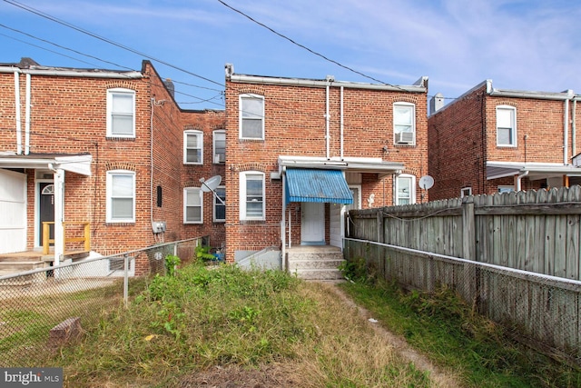 6745 Woodley, Dundalk, MD 21222 - back of house featuring brick siding, a fenced backyard, and entry steps