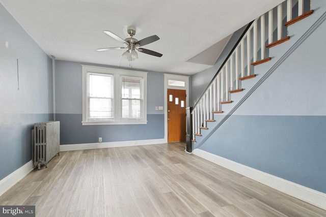 6745 Woodley, Dundalk, MD 21222 - entrance foyer with radiator heating unit, a ceiling fan, stairs, and wood finished floors