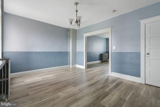6745 Woodley, Dundalk, MD 21222 - unfurnished dining area with a chandelier, wood finished floors, and baseboards