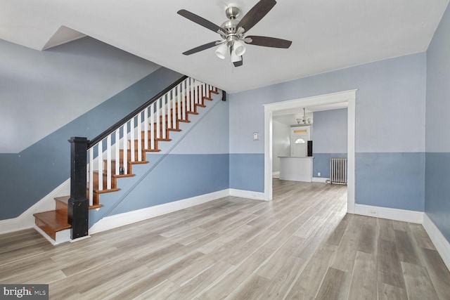 6745 Woodley, Dundalk, MD 21222 - staircase with radiator heating unit, wood finished floors, a ceiling fan, baseboards, and a chandelier