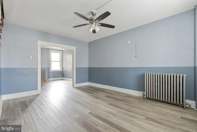 6745 Woodley, Dundalk, MD 21222 - unfurnished room with radiator heating unit, ceiling fan, wood finished floors, and baseboards
