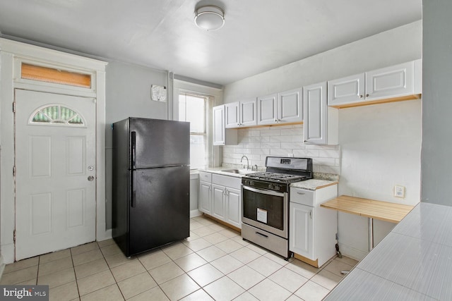 6745 Woodley, Dundalk, MD 21222 - kitchen featuring freestanding refrigerator, gas stove, light countertops, and plenty of natural light