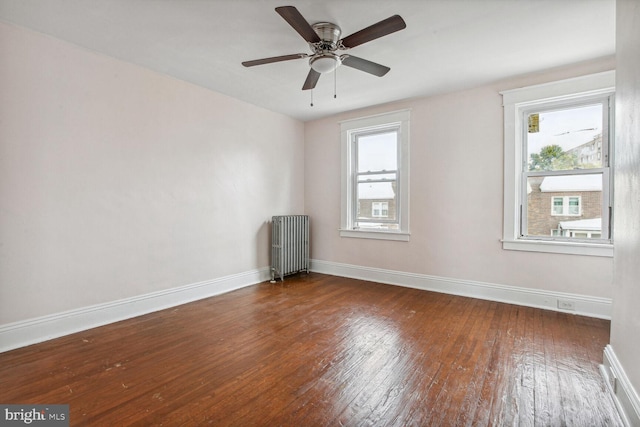 6745 Woodley, Dundalk, MD 21222 - unfurnished room featuring radiator heating unit, hardwood / wood-style flooring, baseboards, and a ceiling fan