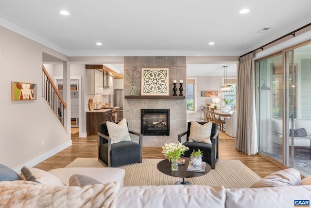 729 Highgate Row, Crozet, VA 22932 - living room with crown molding, recessed lighting, light wood-style flooring, baseboards, and a tile fireplace