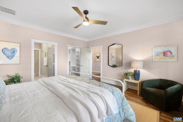 729 Highgate Row, Crozet, VA 22932 - bedroom featuring wood finished floors, crown molding, a spacious closet, baseboards, and ensuite bath