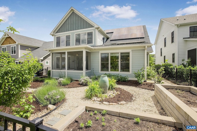 729 Highgate Row, Crozet, VA 22932 - back of house with board and batten siding, a sunroom, solar panels, and roof with shingles