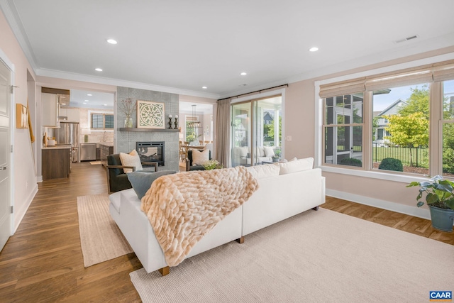 729 Highgate Row, Crozet, VA 22932 - living room featuring crown molding, plenty of natural light, a fireplace, recessed lighting, and baseboards