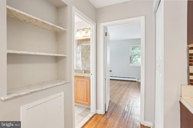 1100 Tyson Ave Unit A-10, Abington, PA 19001 - hall with a baseboard heating unit and light wood finished floors