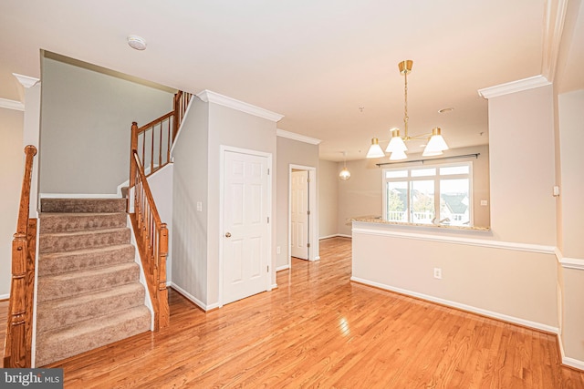 11919 Little Seneca Pkwy, Clarksburg, MD 20871 - unfurnished room featuring light wood-type flooring, crown molding, a chandelier, stairs, and baseboards
