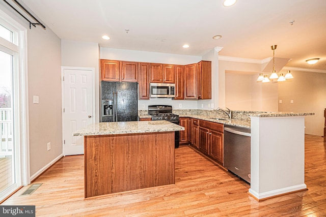 11919 Little Seneca Pkwy, Clarksburg, MD 20871 - kitchen with black appliances, a center island, light wood-style flooring, light stone counters, and crown molding