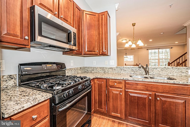 11919 Little Seneca Pkwy, Clarksburg, MD 20871 - kitchen featuring stainless steel microwave, black gas range, a sink, light wood-style floors, and light stone countertops