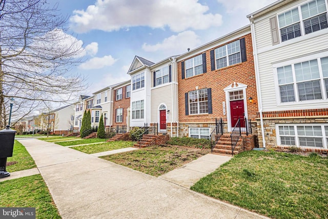 11919 Little Seneca Pkwy, Clarksburg, MD 20871 - townhome / multi-family property with a residential view, a front yard, and brick siding