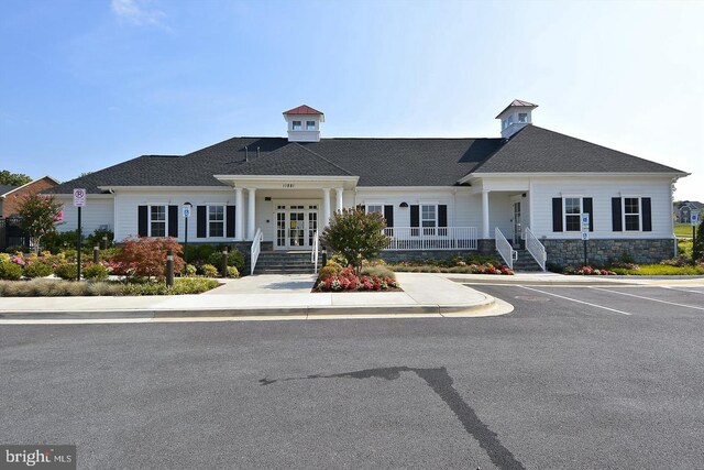 11919 Little Seneca Pkwy, Clarksburg, MD 20871 - view of front of property with stone siding, uncovered parking, french doors, and covered porch