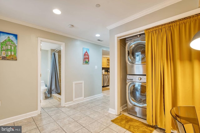 1337 Harvard St NW Unit 1, Washington, DC 20009 - washroom with estacked washer and dryer, ornamental molding, baseboards, light tile patterned floors, and recessed lighting