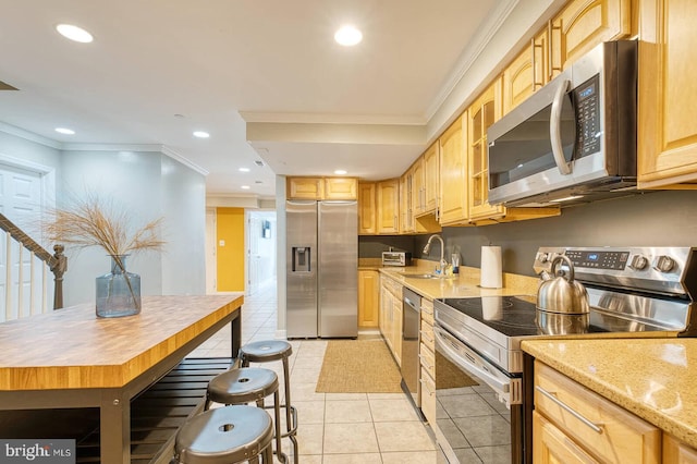 1337 Harvard St NW Unit 1, Washington, DC 20009 - kitchen featuring stainless steel appliances, a sink, crown molding, light brown cabinetry, and light tile patterned flooring