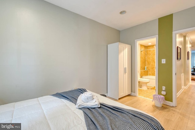 1337 Harvard St NW Unit 1, Washington, DC 20009 - bedroom featuring light wood-style floors, baseboards, and ensuite bathroom