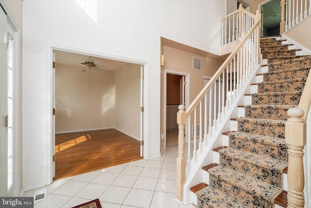 5 Primrose Dr, Burlington Township, NJ 08016 - stairs featuring ceiling fan, tile patterned flooring, a towering ceiling, and baseboards