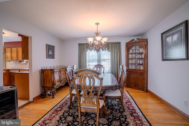 5 Wetherhill Way, Dayton, NJ 08810 - dining area featuring a chandelier, wine cooler, light wood-style flooring, and baseboards