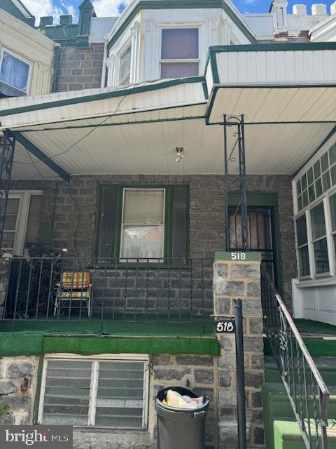 518 S 55th St, Philadelphia, PA 19143 - doorway to property featuring a porch and stone siding