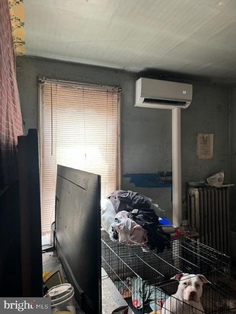 518 S 55th St, Philadelphia, PA 19143 - bedroom featuring a wall mounted AC and radiator heating unit