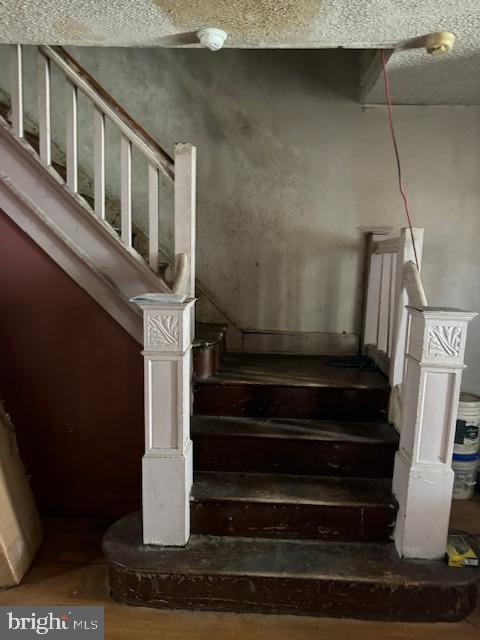 518 S 55th St, Philadelphia, PA 19143 - stairs with a textured ceiling
