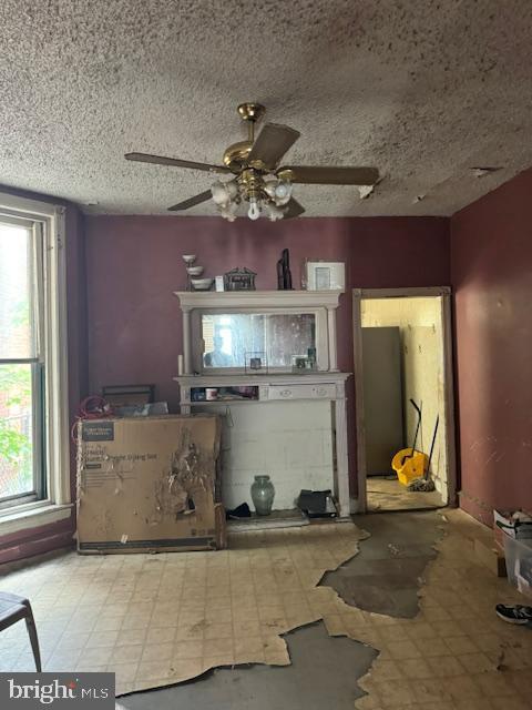 518 S 55th St, Philadelphia, PA 19143 - unfurnished living room featuring a ceiling fan, tile patterned floors, and a textured ceiling