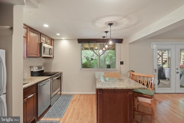 3615 22nd St N, Arlington, VA 22207 - kitchen with appliances with stainless steel finishes, french doors, a breakfast bar area, light wood-style flooring, and recessed lighting