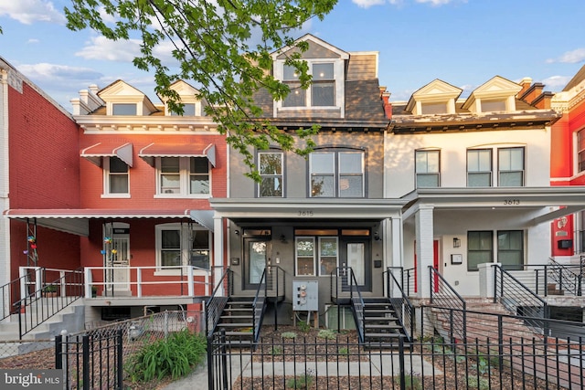 3615 10th St NW Unit A, Washington, DC 20010 - multi unit property featuring covered porch, brick siding, a fenced front yard, and stairway