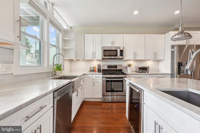 3615 10th St NW Unit A, Washington, DC 20010 - kitchen featuring stainless steel appliances, wine cooler, white cabinets, dark wood-style floors, and decorative backsplash