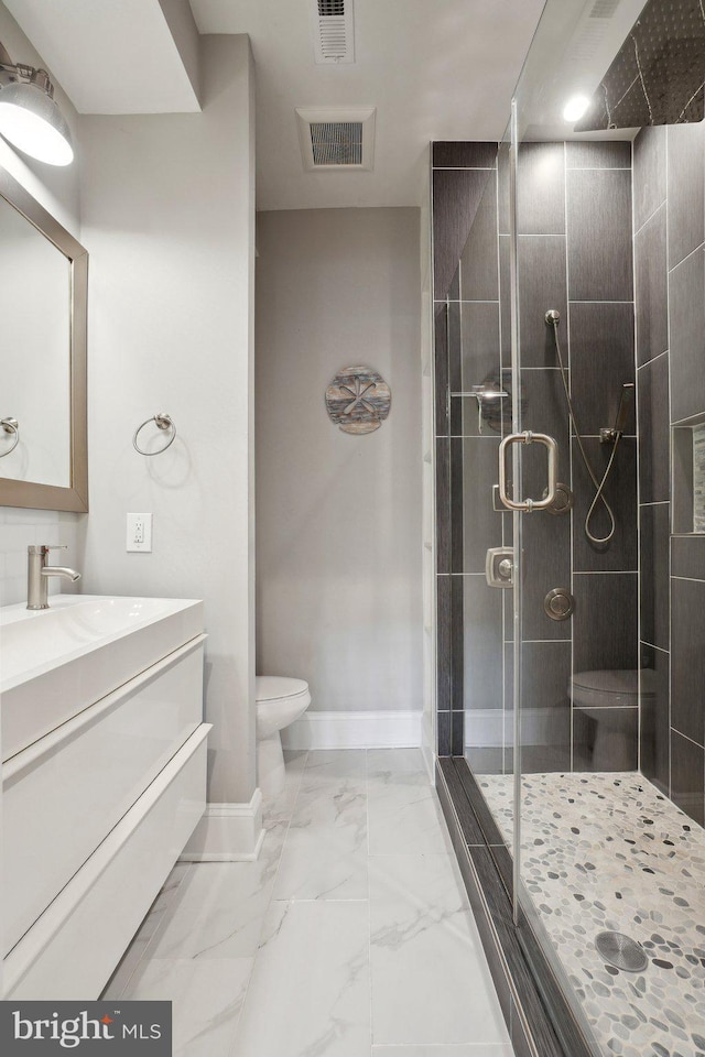 3615 10th St NW Unit A, Washington, DC 20010 - bathroom featuring a stall shower, vanity, toilet, marble look tiles, and baseboards