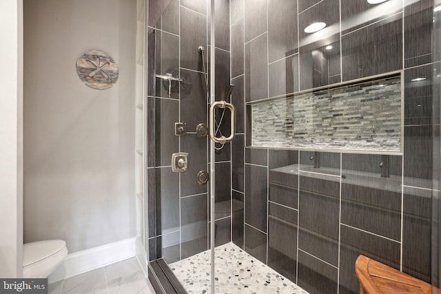 3615 10th St NW Unit A, Washington, DC 20010 - bathroom featuring toilet, a stall shower, marble finish floors, and baseboards