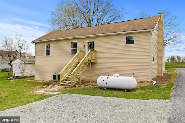106 1st Ave, Lincoln University, PA 19352 - back of property featuring central air condition unit, a chimney, and a lawn